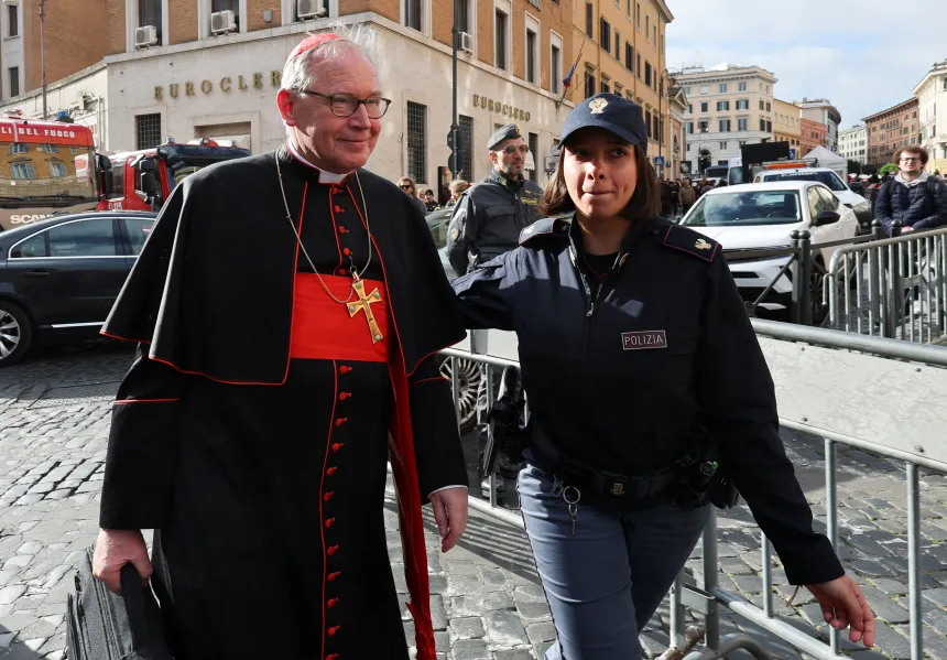 Kardinal Eijk går ved siden av en politikvinne på gaten i Roma