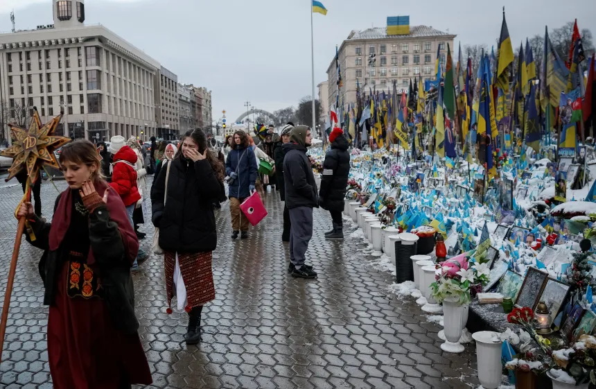 Folk går forbi et minnesmerke for falne soldater på Uavhengighetsplassen i Kyiv